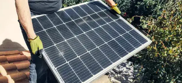 a person carrying a solar panel